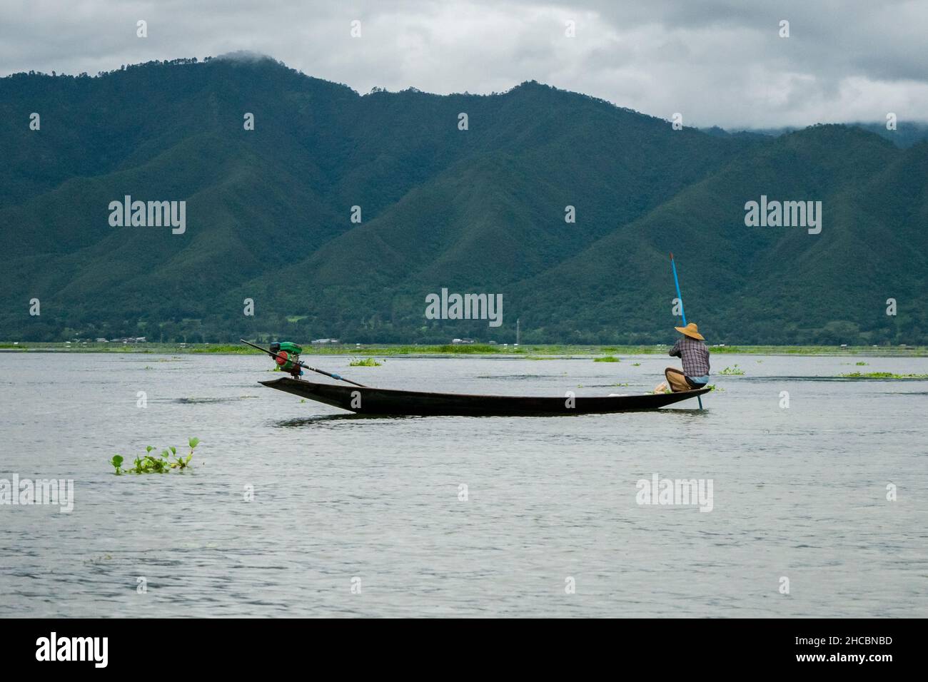 Un birman, à la pointe du bateau ou du kayak, pêchant avec des filets et manvolant son bateau au lac Inle Banque D'Images