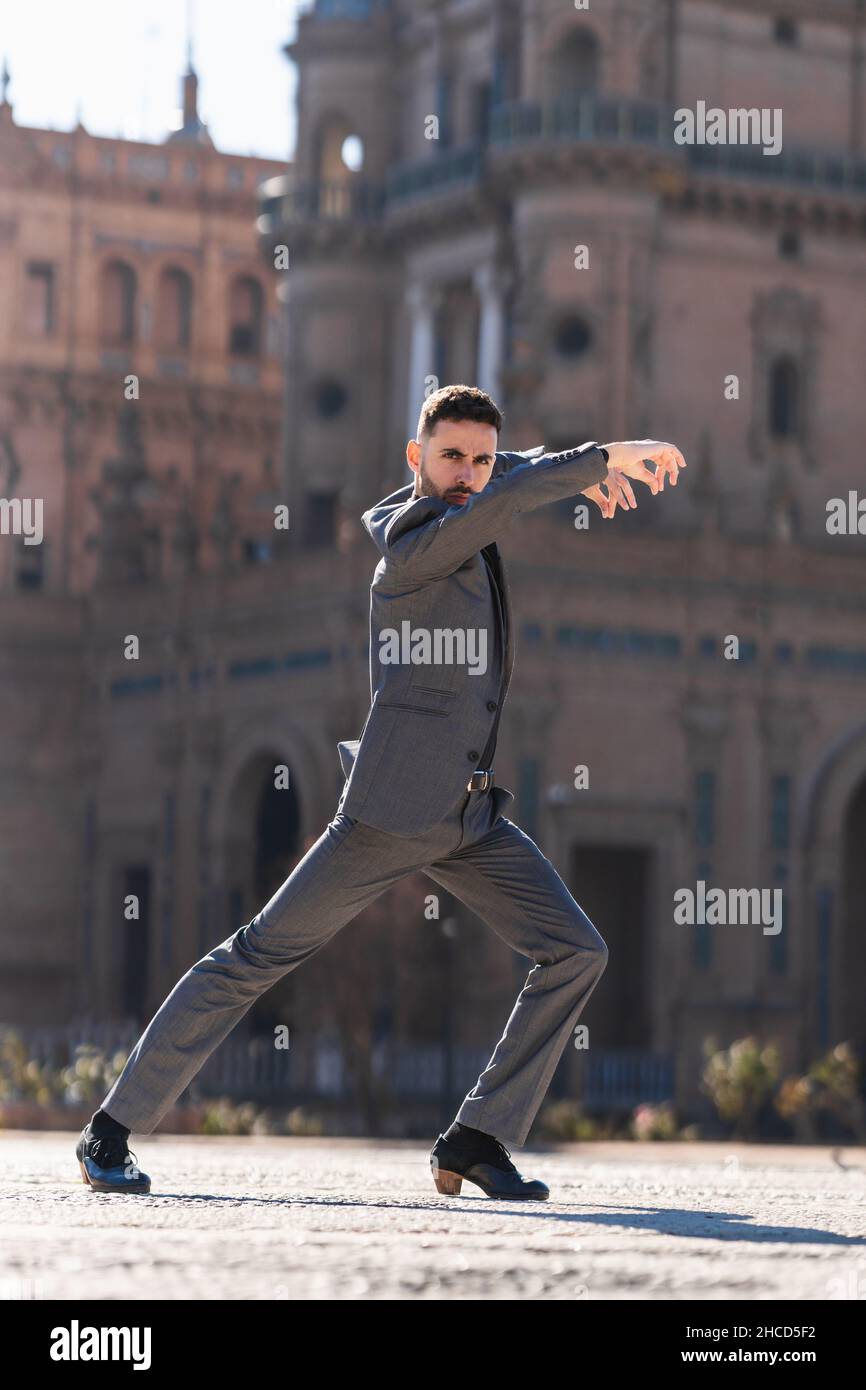 Homme en costume gris dansant le flamenco avec énergie Banque D'Images