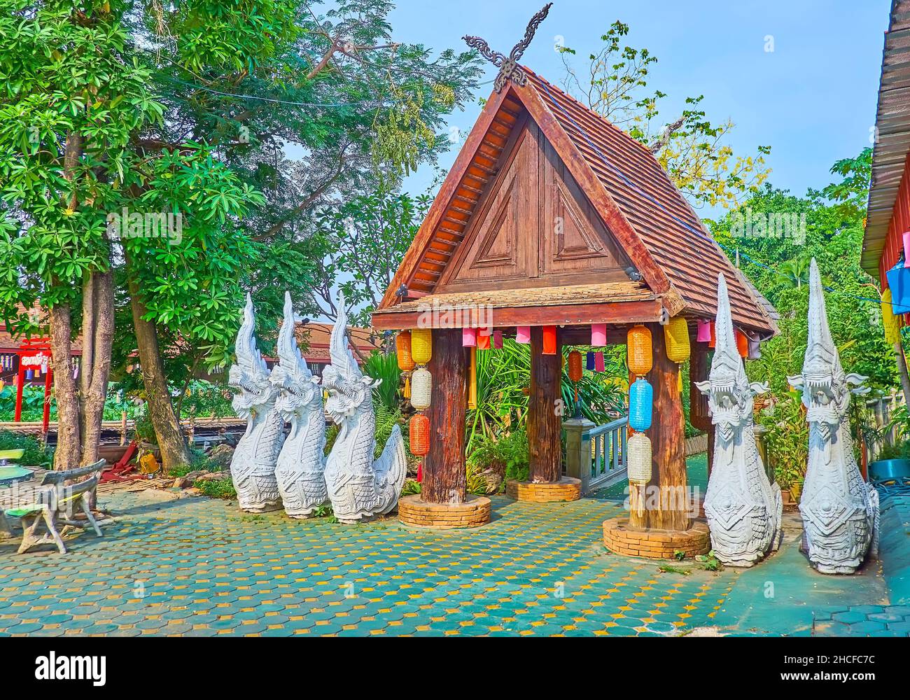 L'ancienne porte en bois du jardin de Wat Jedlin est entourée de gardes serpents en plâtre blanc Naga, Chiang Mai, Thaïlande Banque D'Images