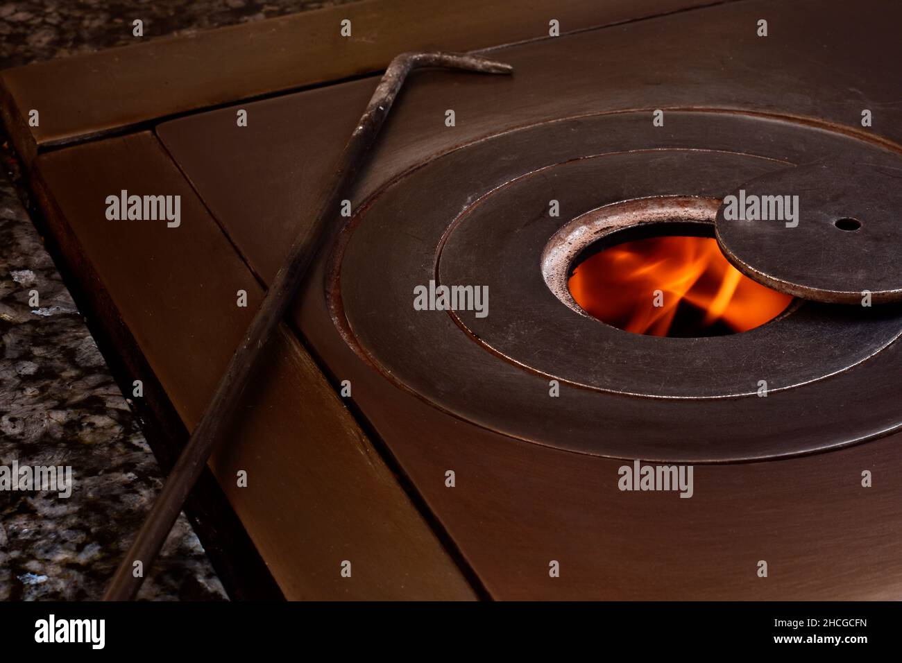 Photographie d'un feu dans un poêle à charbon de bois.la photo a un style vintage et est prise en format horizontal. Banque D'Images