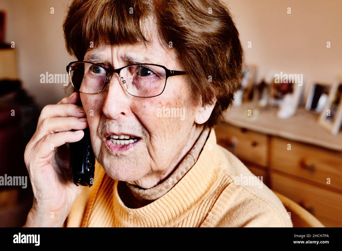 Senior à la maison regardant surpris tout en téléphonant, petit-fils tour, Cologne, Rhénanie-du-Nord-Westphalie, Allemagne Banque D'Images