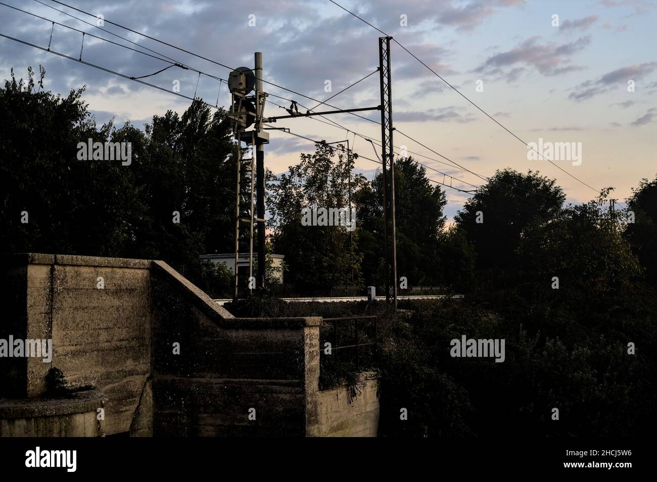 Chemin de fer sur un pont par une journée nuageux au coucher du soleil Banque D'Images