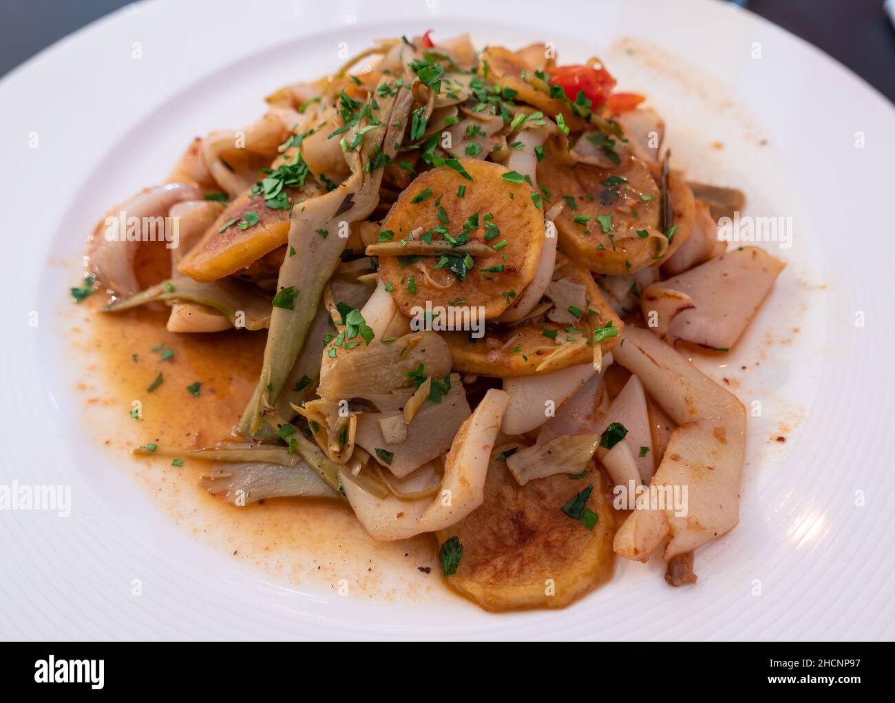 Un plat méditerranéen typique - calamars avec des artichauts et des légumes Banque D'Images