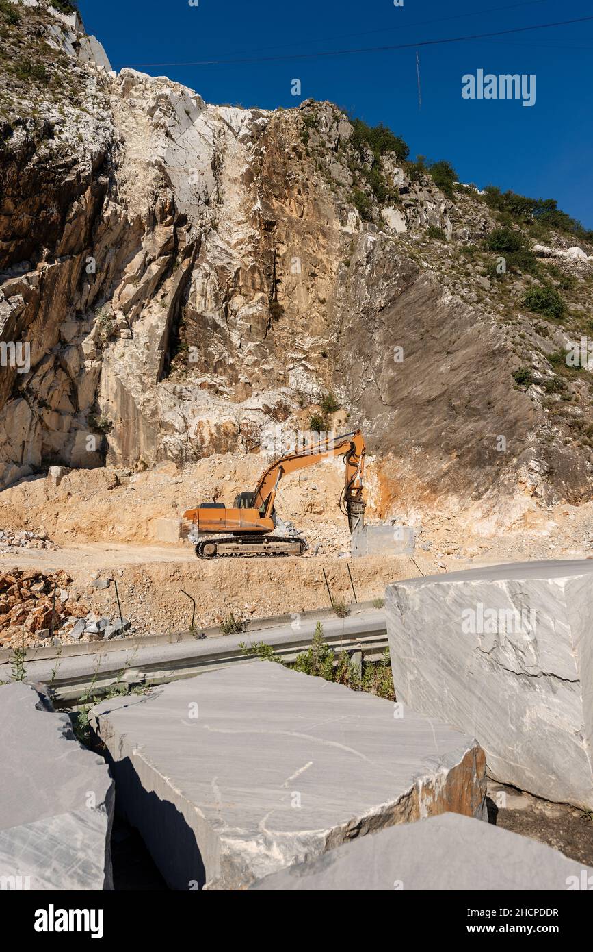 Pelle tracker orange avec le marteau dans une carrière de marbre (marbre blanc Carrare) dans les Alpes Apuanes (Alpi Apuane).Toscane, Italie, Europe. Banque D'Images