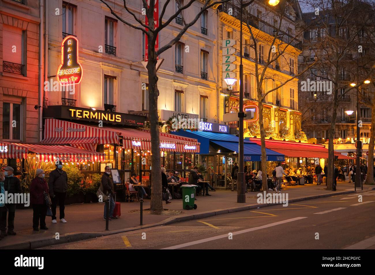 Paris, France - 30 décembre 2021 : vue sur une rue parisienne très animée avec des restaurants et des bars la nuit Banque D'Images