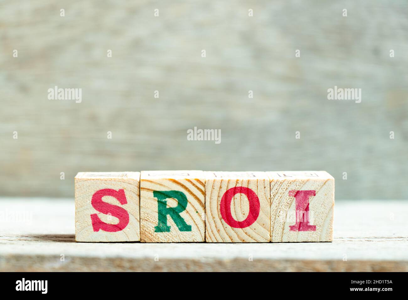 Bloc de lettres de l'alphabet dans le mot SROI (abréviation du retour sur investissement social) sur fond de bois Banque D'Images