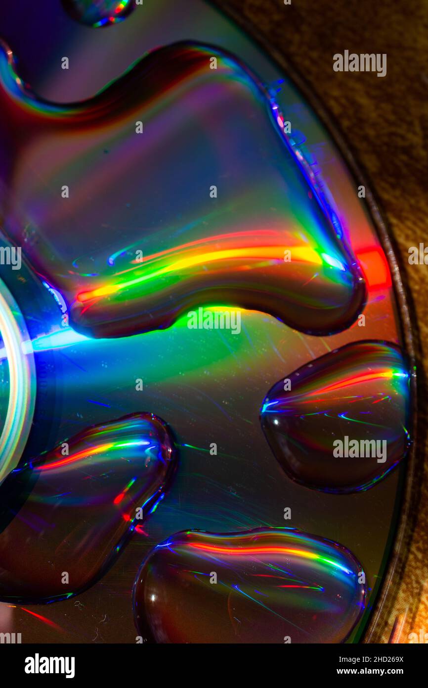 Vue de dessus des grosses gouttes d'eau sur la surface du disque créant un effet de couleurs arc-en-ciel Banque D'Images