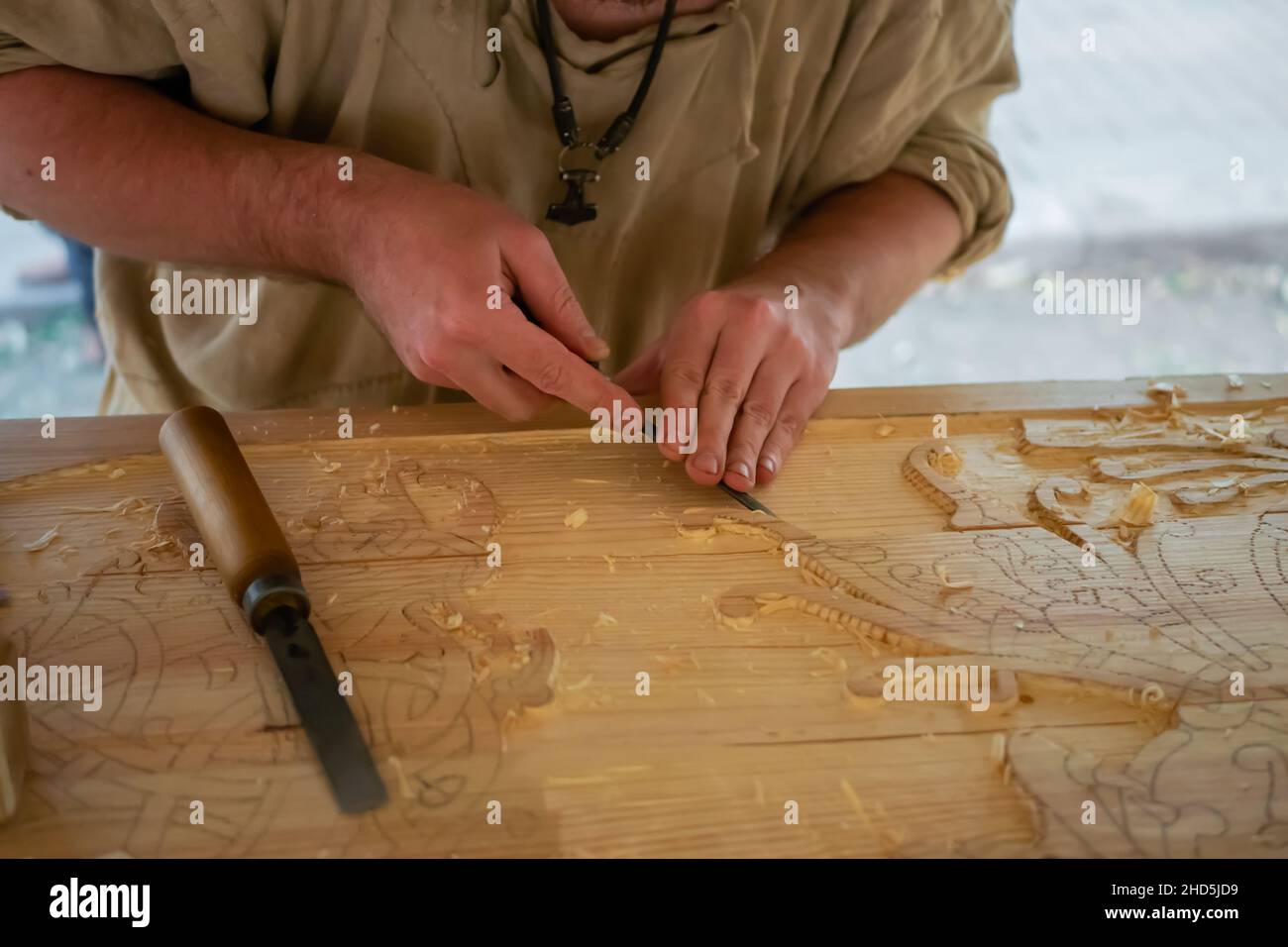 Carpenter sculptant du bois avec burin au festival medival - gros plan Banque D'Images