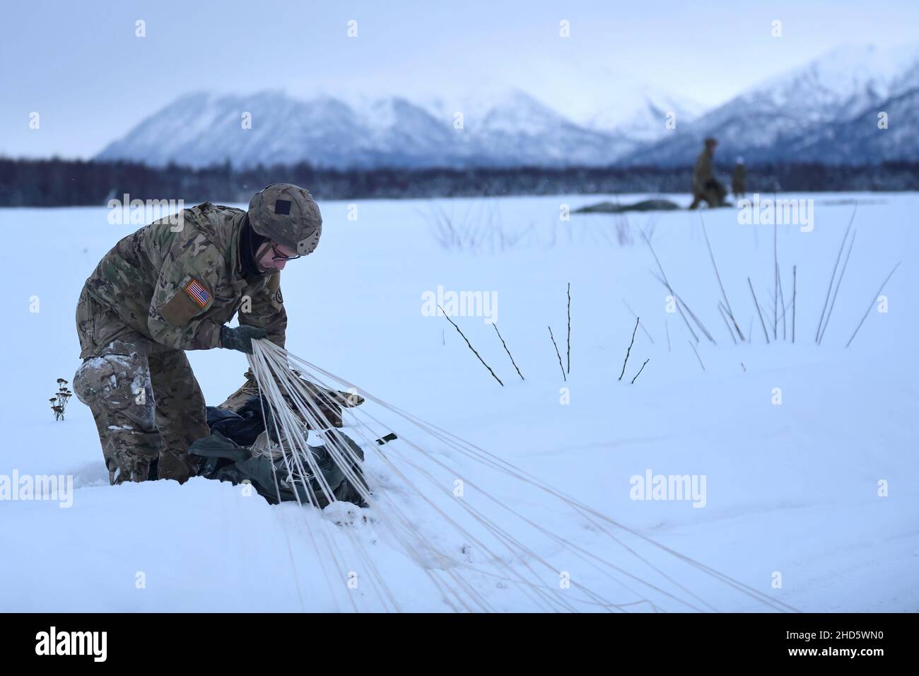 9 décembre 2021 - base conjointe Elmendorf-Richardson, Alaska, États-Unis - Sgt.Corbin Huxley, 4th Infantry Brigade combat Team (Airborne), 25th Infantry Division, rassemble son parachute après avoir participé à l'opération Toy Drop, une opération aérienne dans la zone de chute de Malemute, base interarmées Elmendorf-Richardson, Alaska, le 9 décembre 2021.Les parachutistes ont fait don de jouets à des organismes de bienfaisance locaux et ont mené une opération aérienne avec un capitaine de macaron chilien, gagnant leurs ailes de saut chilien et diffusant les fêtes de fin d'année à leur communauté locale.Credit: Armée américaine /ZUMA Press Wire Service/ZUMAPRESS.com/Alamy Live News Banque D'Images