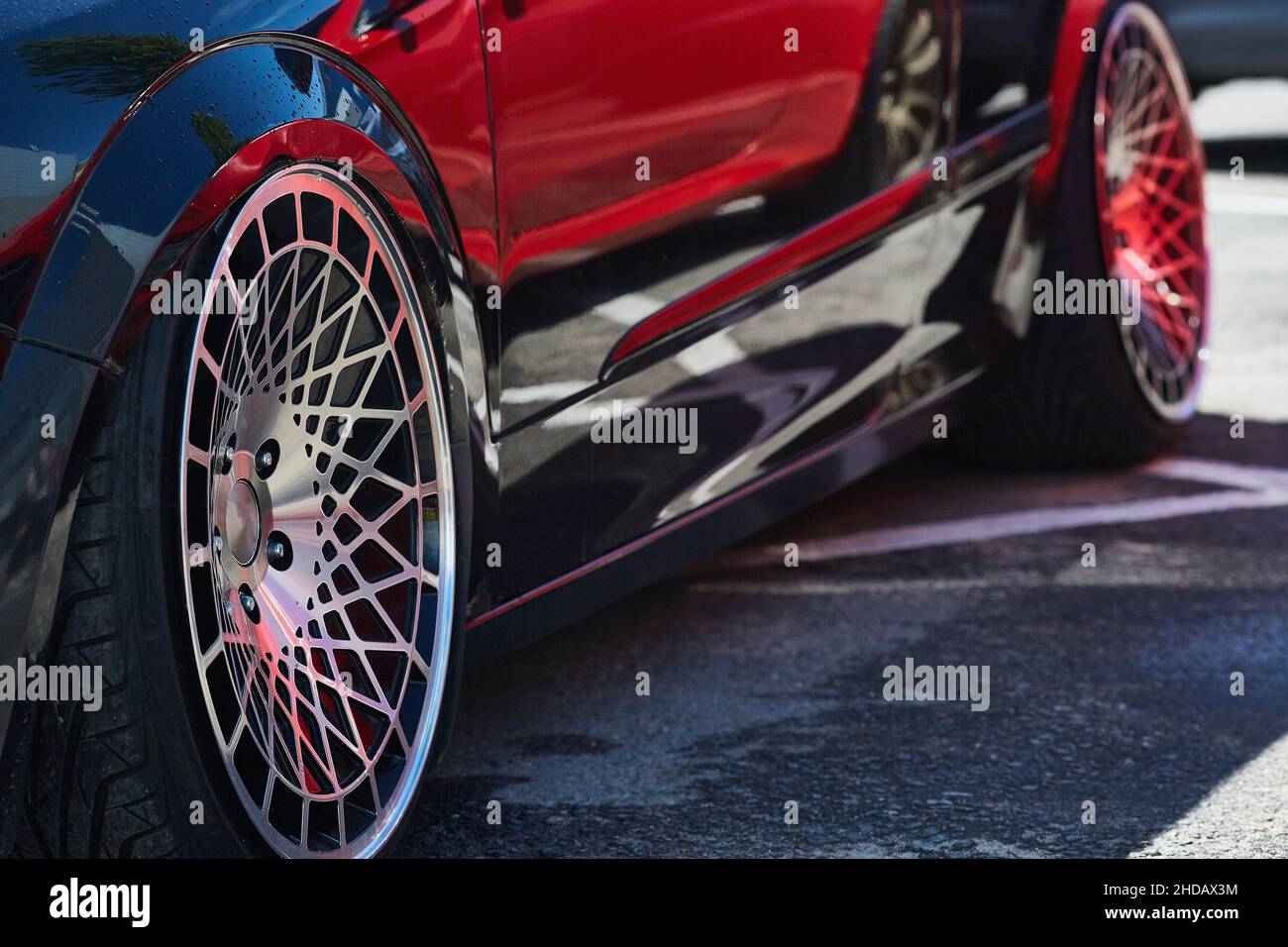 roue réglée d'une voiture noire chère par une belle journée d'été. Banque D'Images