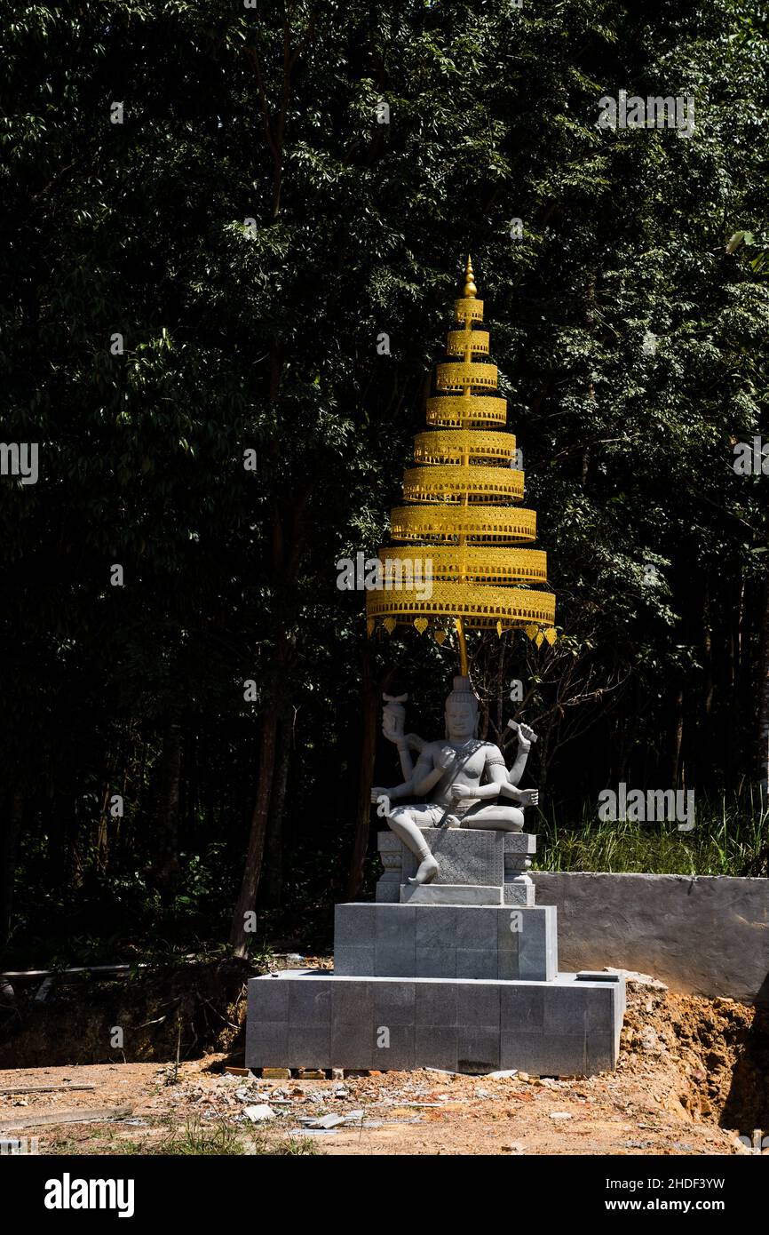 Photo verticale d'une ancienne statue construite dans la forêt Banque D'Images