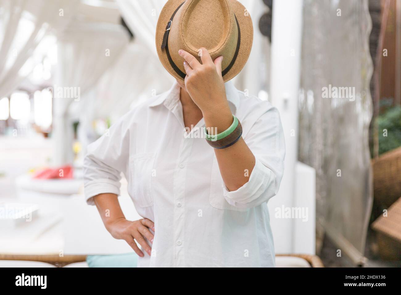 L'homme couvre son visage avec une pomme.Au lieu d'un visage, une pomme.L'homme en noir.L'homme dans le chapeau. Banque D'Images