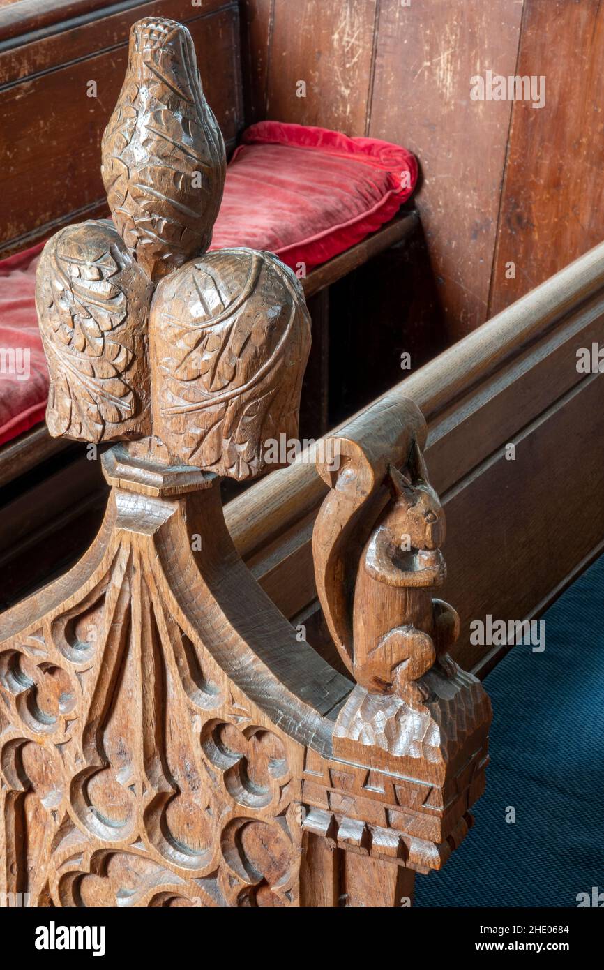 Une extrémité de banc sculptée par M. Langman de Framlingham dans le style du 14th siècle à l'église Saint-Pierre, Charsfield, Suffolk Banque D'Images