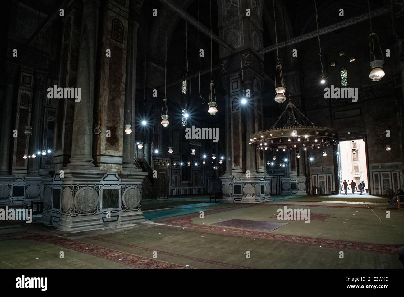 La salle de prière intérieure avec des colonnes en marbre et des lumières suspendues dans la mosquée Al-Rifai au Caire, en Égypte. Banque D'Images