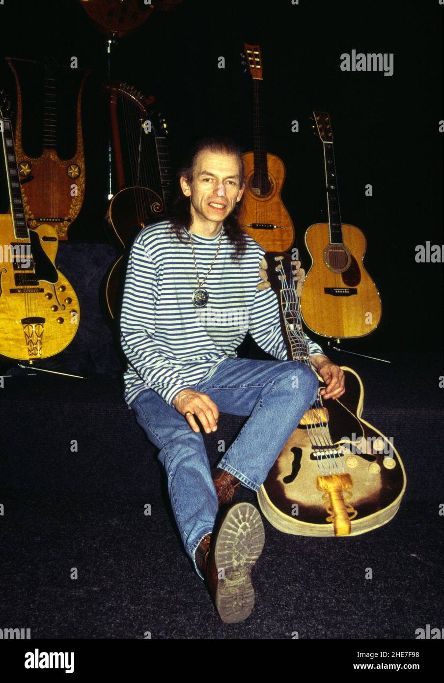 Le guitariste anglais Steve Howe avec une partie de sa collection de guitares, Londres, 1995.Celui qu'il tient est en fait une guitare 'câly toy'. Banque D'Images