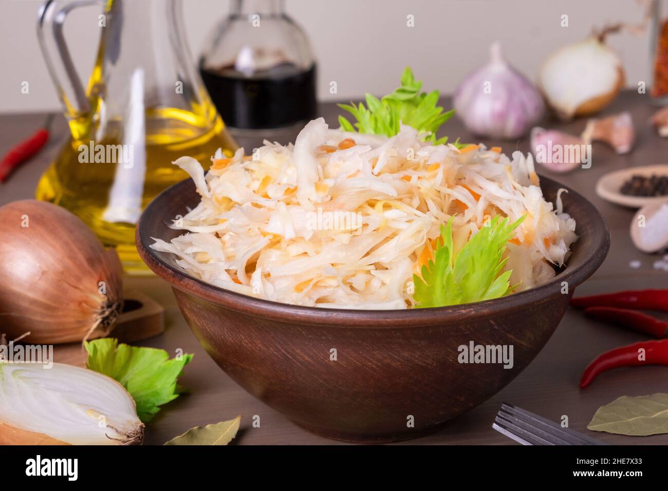 Gros plan du chou fermenté de choucroute dans un bol en céramique de choucroute sur table avec épices et ingrédients.Une alimentation saine et saine.Cuisine russe.Sélection Banque D'Images