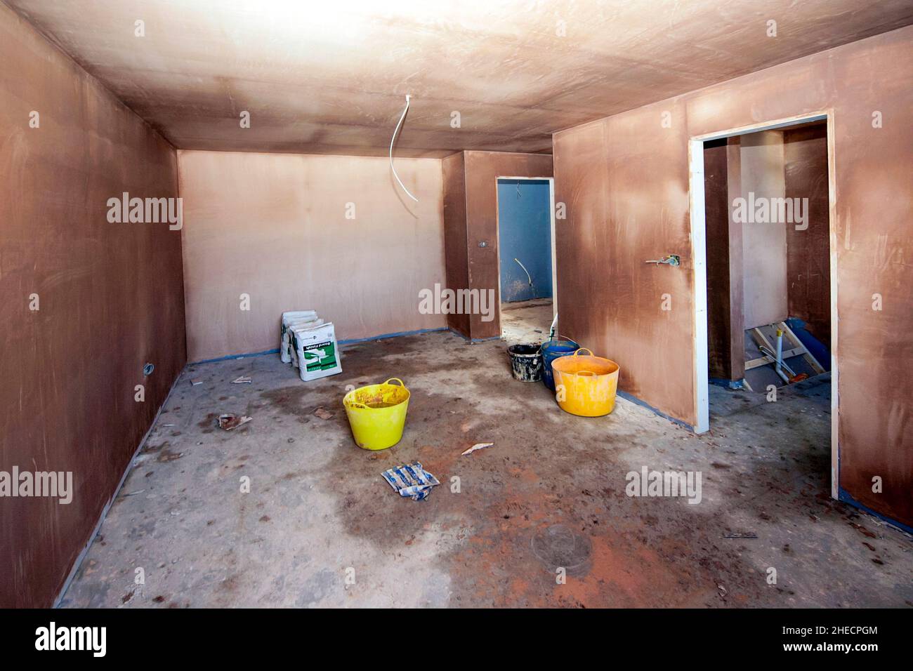 Intérieur fraîchement plâtré d'une maison moderne de construction nouvelle, portes prêtes à être installées, câblage incomplet, séchage Banque D'Images