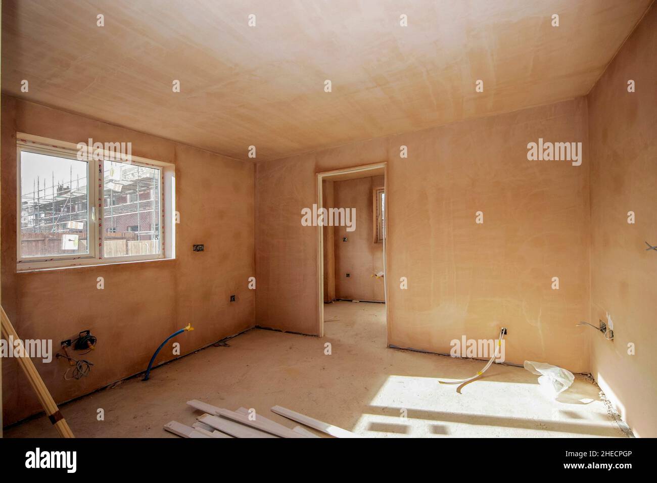 Intérieur fraîchement plâtré d'une maison moderne de construction nouvelle, portes prêtes à être installées, câblage incomplet, séchage Banque D'Images