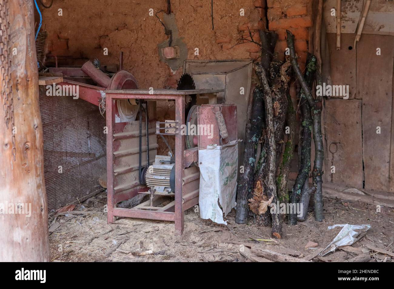 Un hangar dans le village avec une ancienne scie pour couper du bois et d'autres articles ruraux Banque D'Images