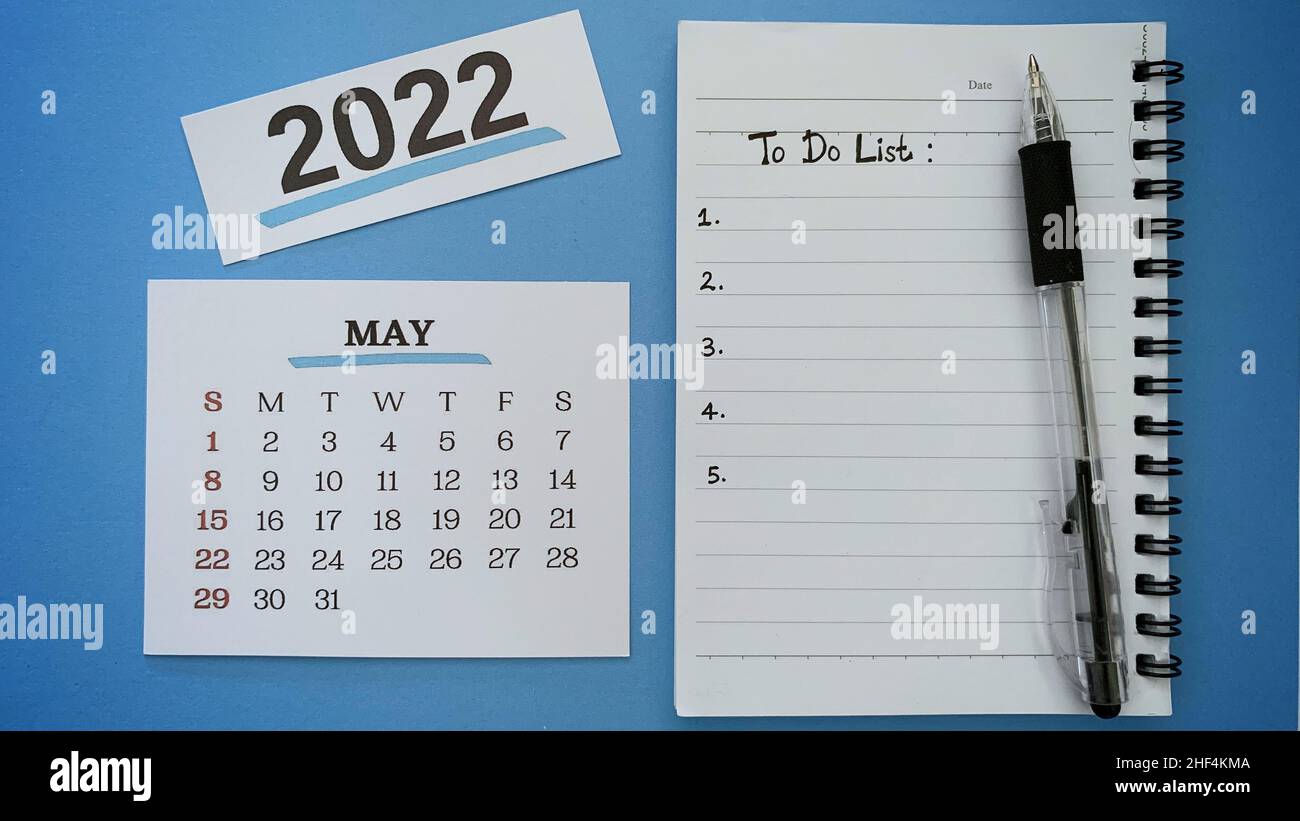 Texte de liste des tâches écrit à la main sur le bloc-notes pour le mois de mai 2022 avec fond bleu.concept de la nouvelle année 2022. Banque D'Images