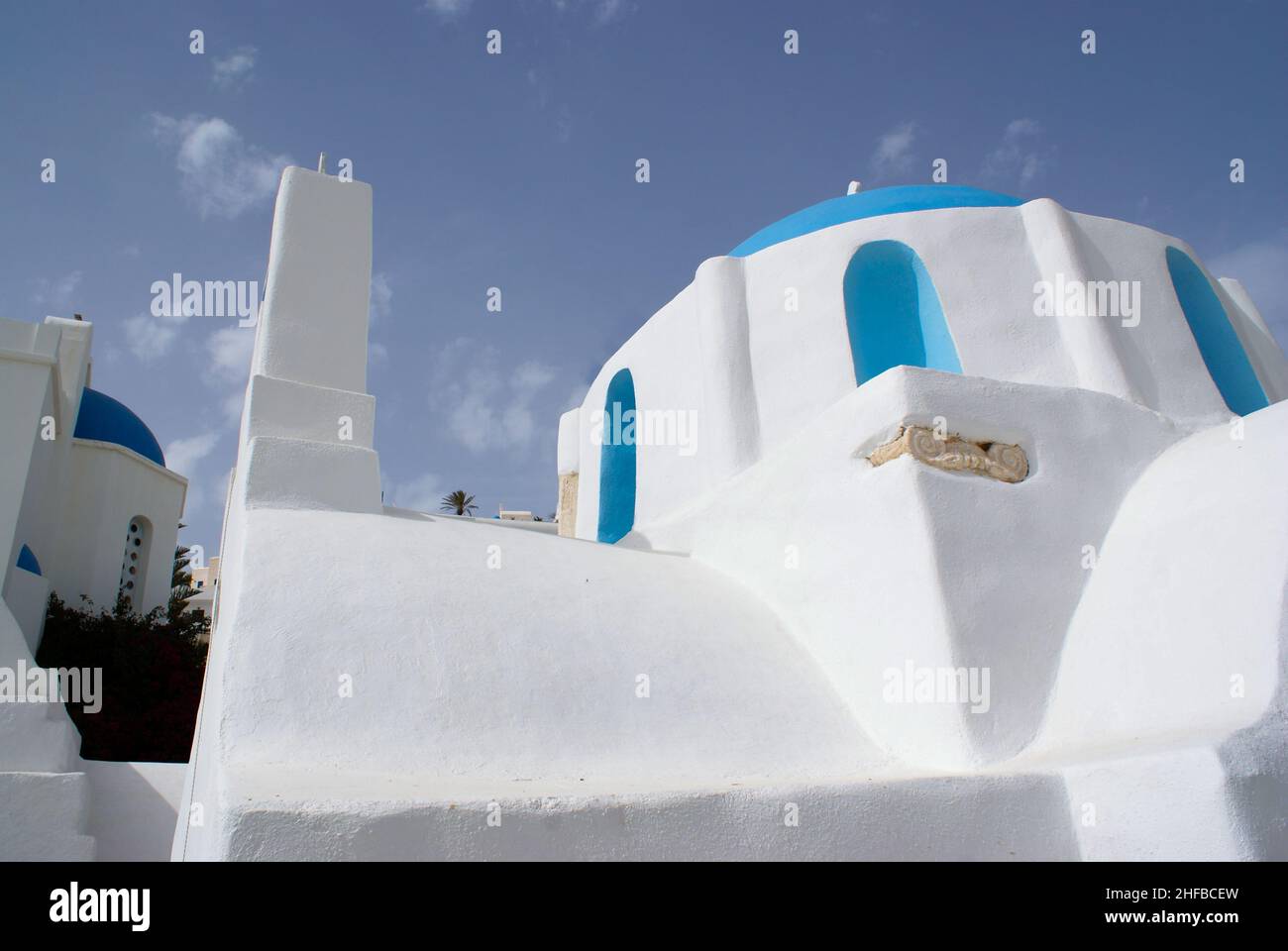 Petite église grecque, île d'iOS.Vue angulaire du vieux bâtiment traditionnel.Architecture simple et authentique.Prise de vue à angle bas.Bleu ciel et espace de copie. Banque D'Images