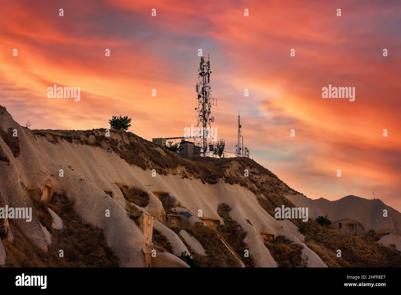 Vue aérienne des antennes TV du mât des télécommunications au coucher du soleil sur la montagne Banque D'Images