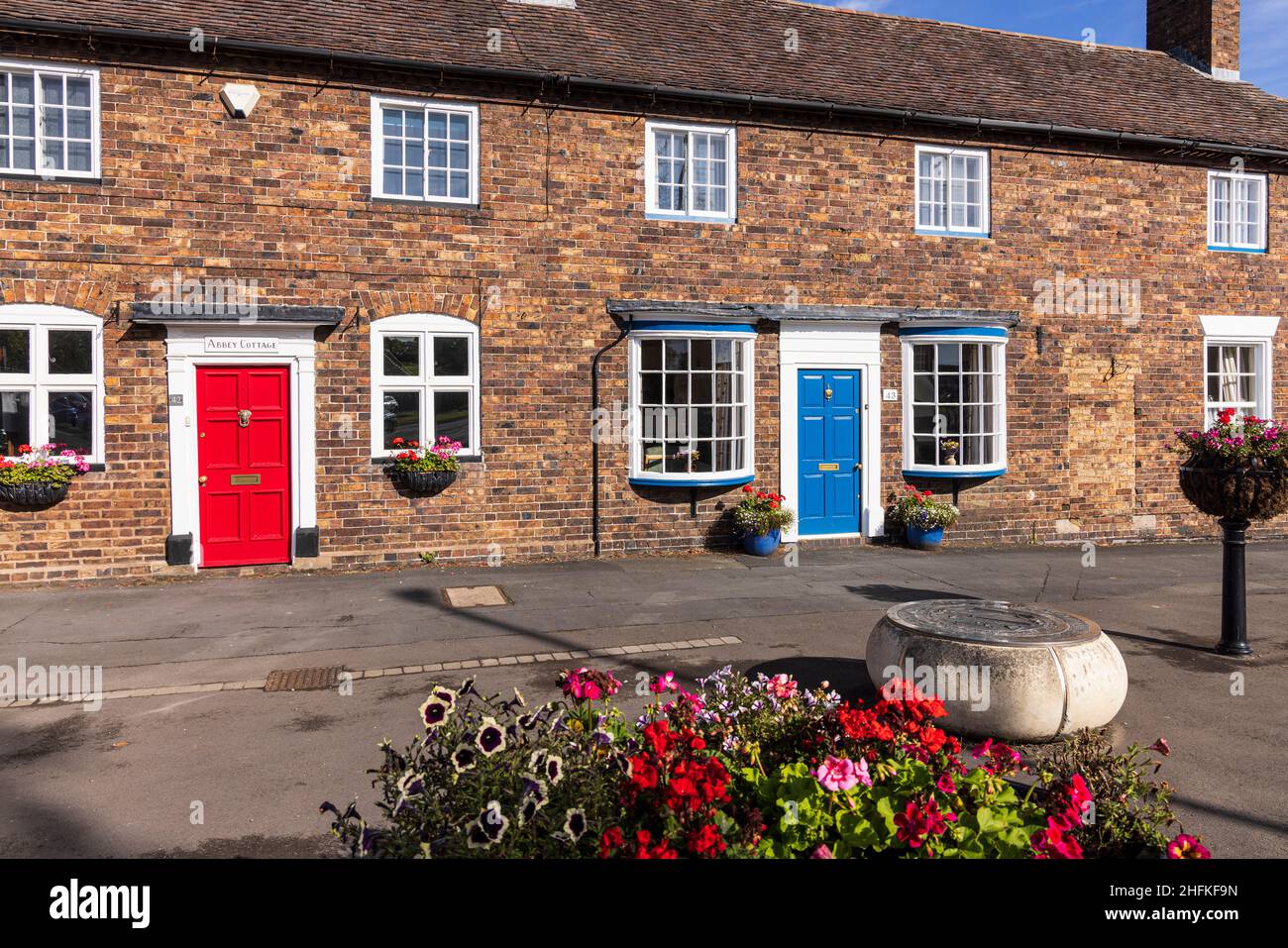 Maisons mitoyennes en briques rouges sur la rue High Street dans la ville de Wenlock, Shropshire, Angleterre Banque D'Images
