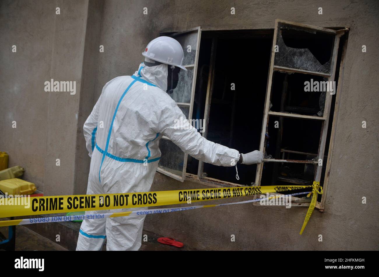 (220117) -- KAMPALA, le 17 janvier 2022 (Xinhua) -- Un expert en médecine légale des incendies recueille des preuves sur les lieux après une éclosion d'incendie à New Crest Junior à l'école primaire Kibedi Day and Boarding dans la division de Kawempe, dans la banlieue de Kampala, en Ouganda, le 15 janvier 2022.Quatre enfants de l'école sont morts samedi dans l'incendie, a déclaré la police samedi.(Photo de Nicholas Kajoba/Xinhua) Banque D'Images