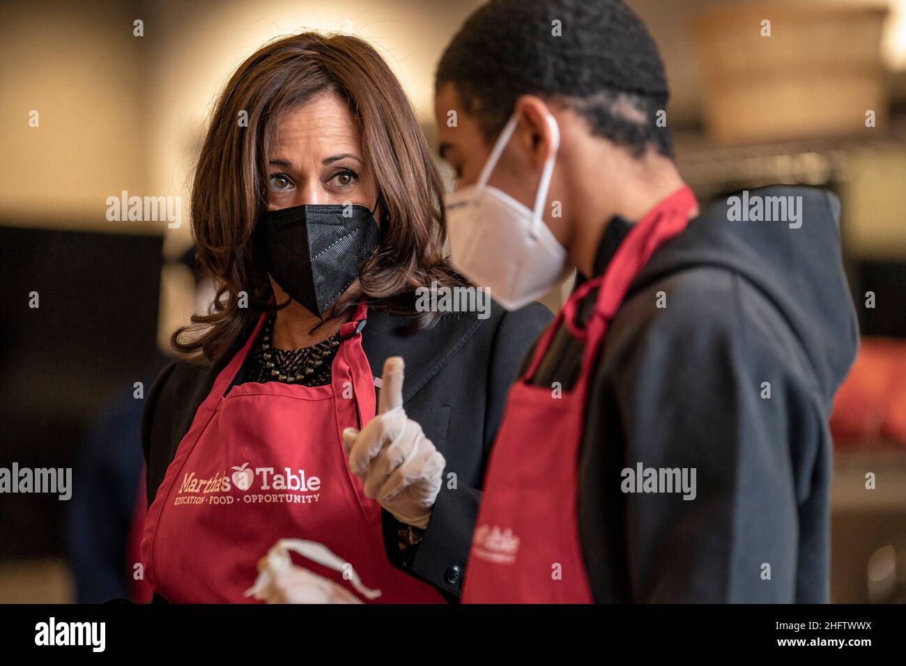 Le vice-président des États-Unis, Kamala Harris, discute avec le bénévole Brian Williams, 15 ans, alors qu'elle participe à un événement de service communautaire à Marthas Kitchen à Washington, DC, le lundi 17 janvier 2022.Crédit: Ken Cedeno/Pool via CNP Banque D'Images