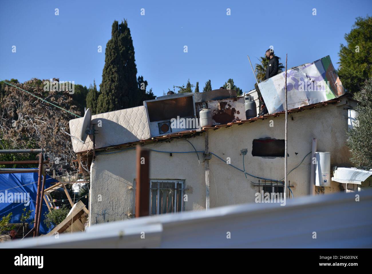 La police israélienne a détruit la pépinière familiale du Sahlhiya et a expulsé le contenu de leur maison à Sheikh Jarrah.Le terrain qui a été exproprié par la municipalité de Jérusalem est désigné, selon la municipalité, pour être utilisé pour la construction d'installations éducatives pour le quartier.La famille était montée sur le toit avec des bouteilles de carburant et de gaz - menaçant de se brûler au cas où les résidents seraient expulsés de force.17th janvier 2022.(Matan Golan/Alay Live News) Banque D'Images