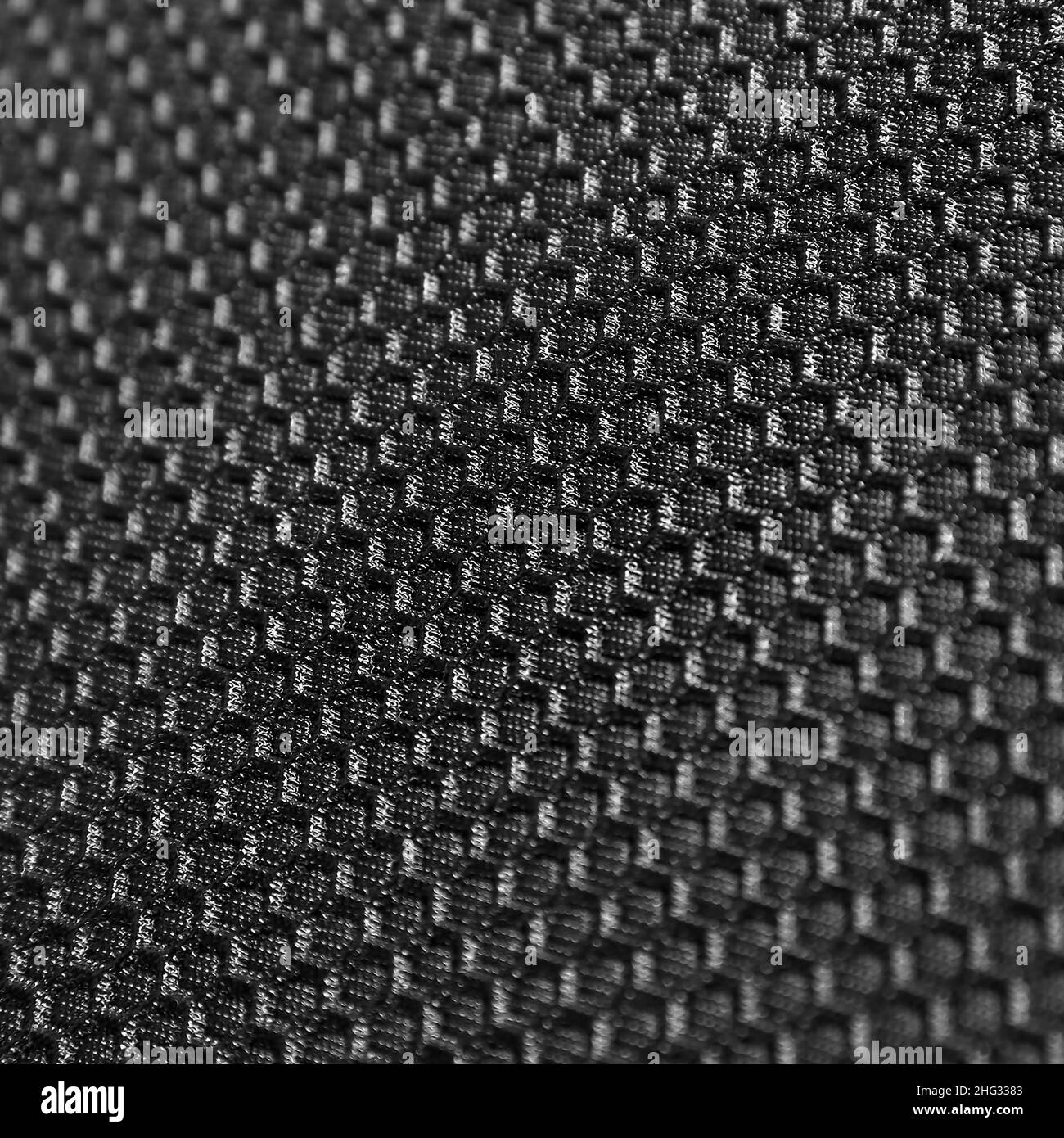 Texture d'arrière-plan en cuir noir avec motif en nid d'abeille, macro Banque D'Images