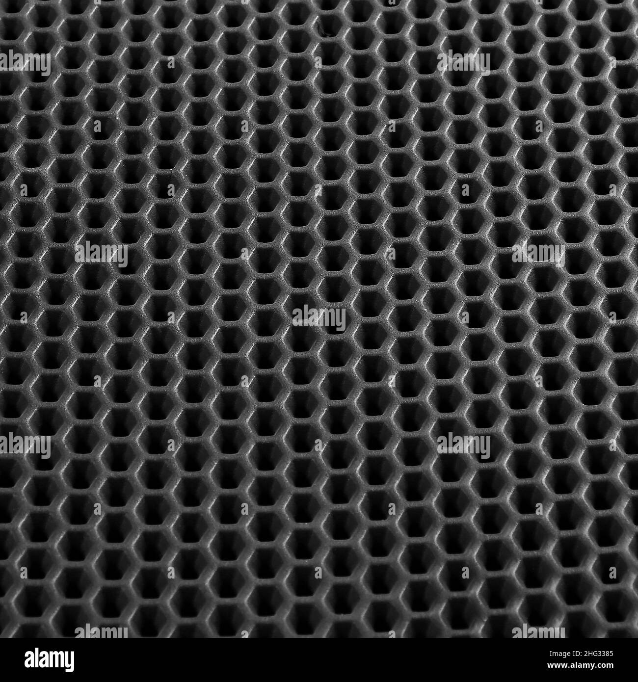 Texture d'arrière-plan en cuir noir avec motif en nid d'abeille, macro Banque D'Images