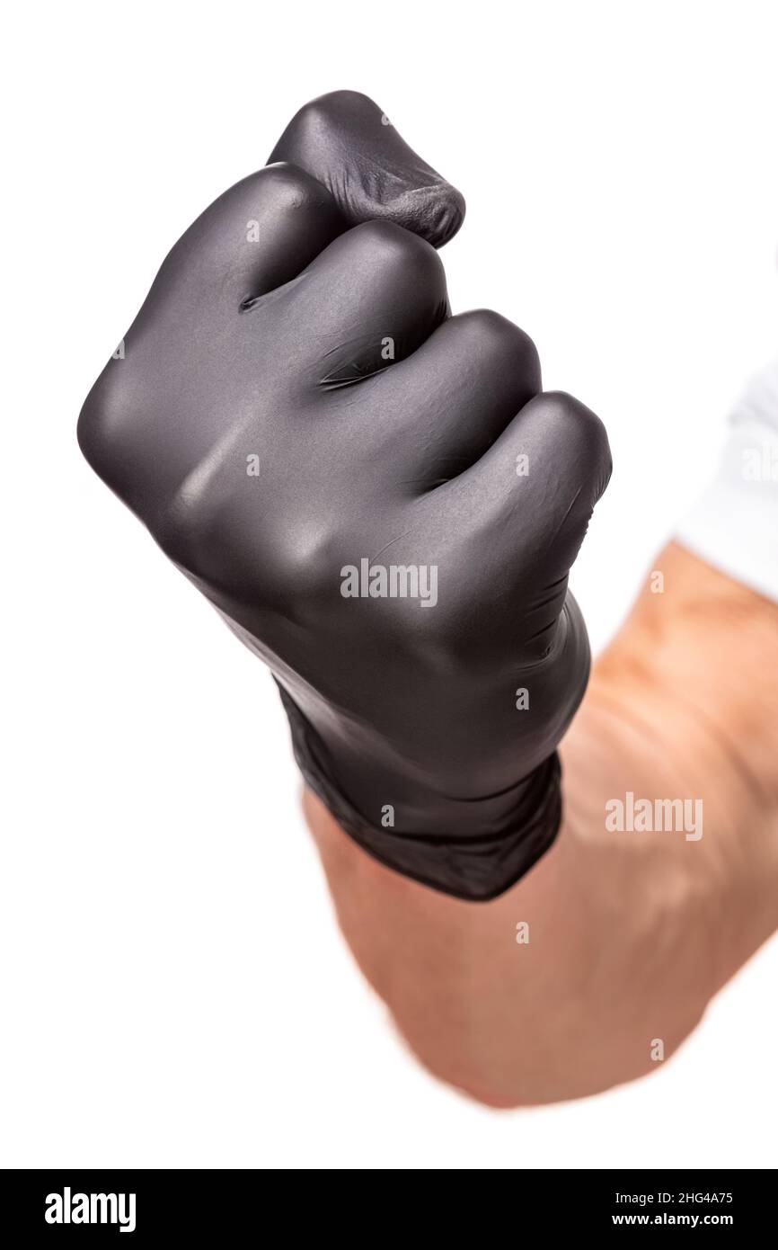 Poing en caoutchouc noir gant isolé sur fond blanc.Poing serré comme  symbole de menace, gros plan Photo Stock - Alamy
