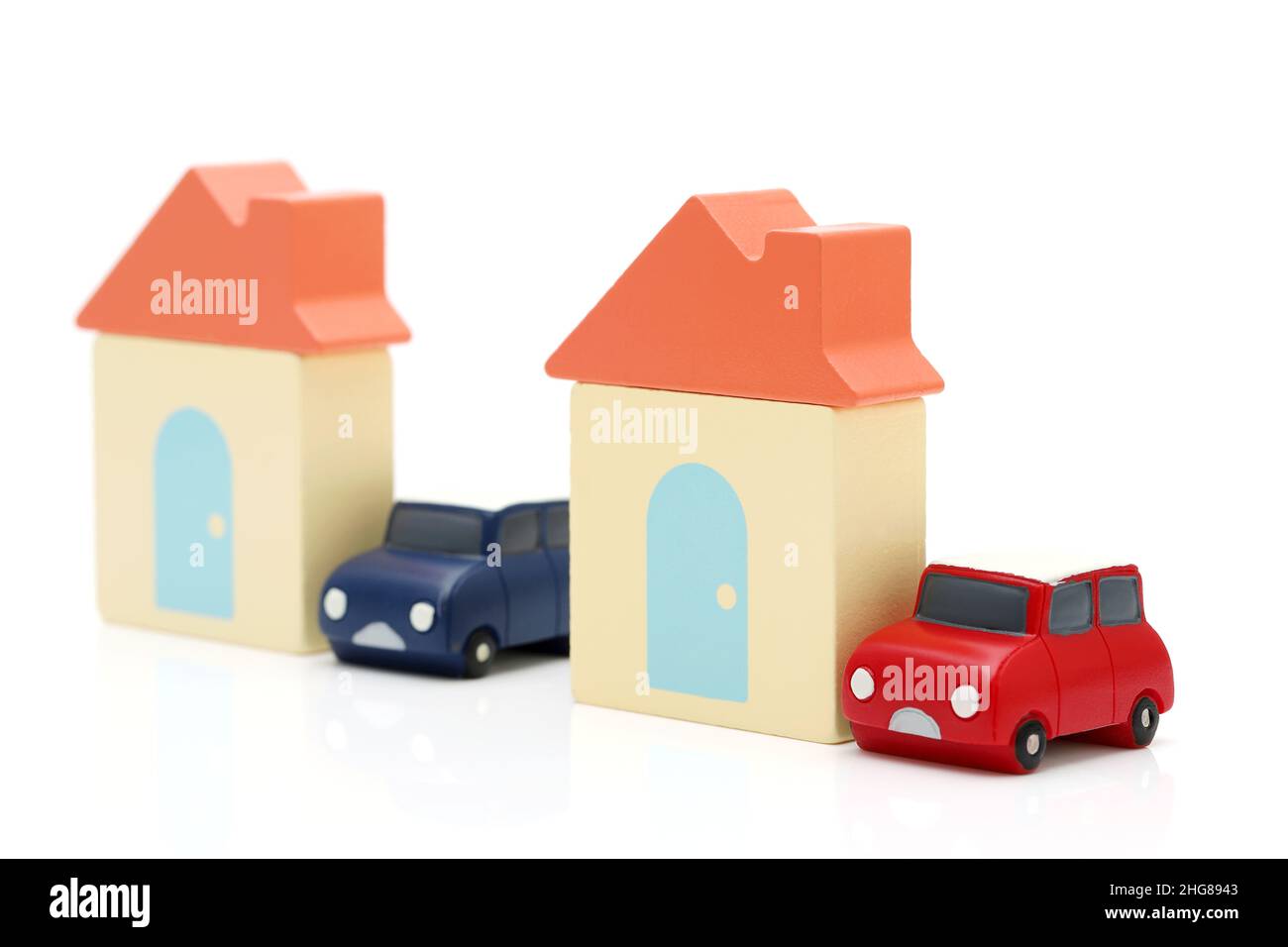 Maison de jouets en bois et voiture de jouets isolée sur fond blanc Banque D'Images
