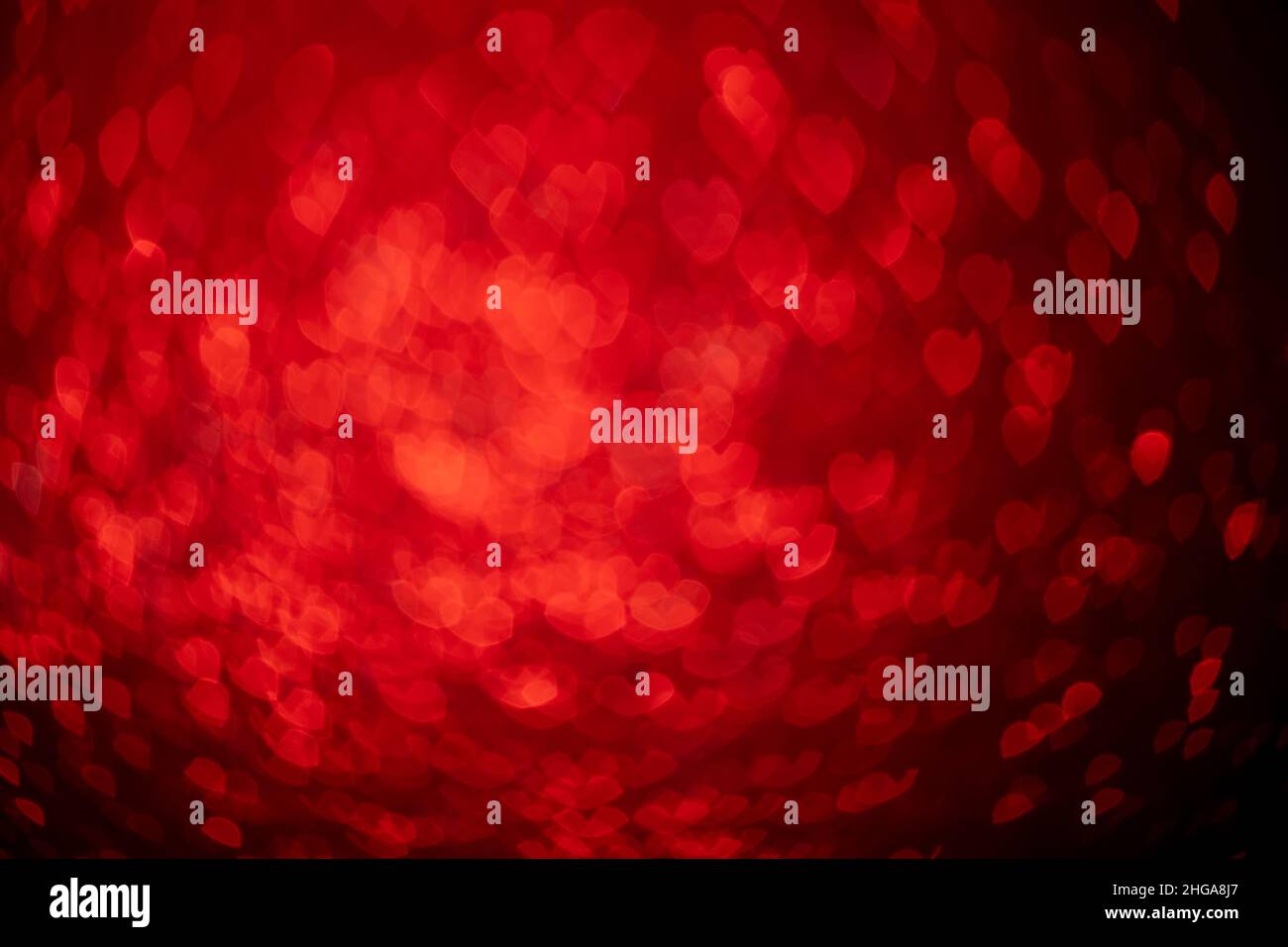 Coeurs rouges, fond de bokeh scintillant, Saint Valentin abstrait texture défocused Banque D'Images