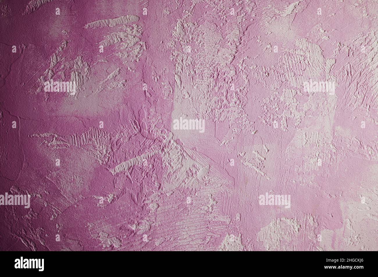 Macro de surface murale abstraite de couleur rose texturée Banque D'Images