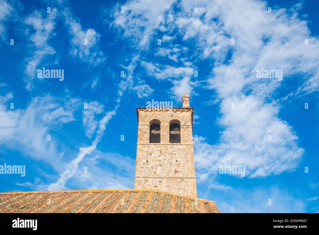 Tour de l'église contre ciel nuageux.Zarzuela del Monte, province de Ségovie, Castilla Leon, Espagne. Banque D'Images