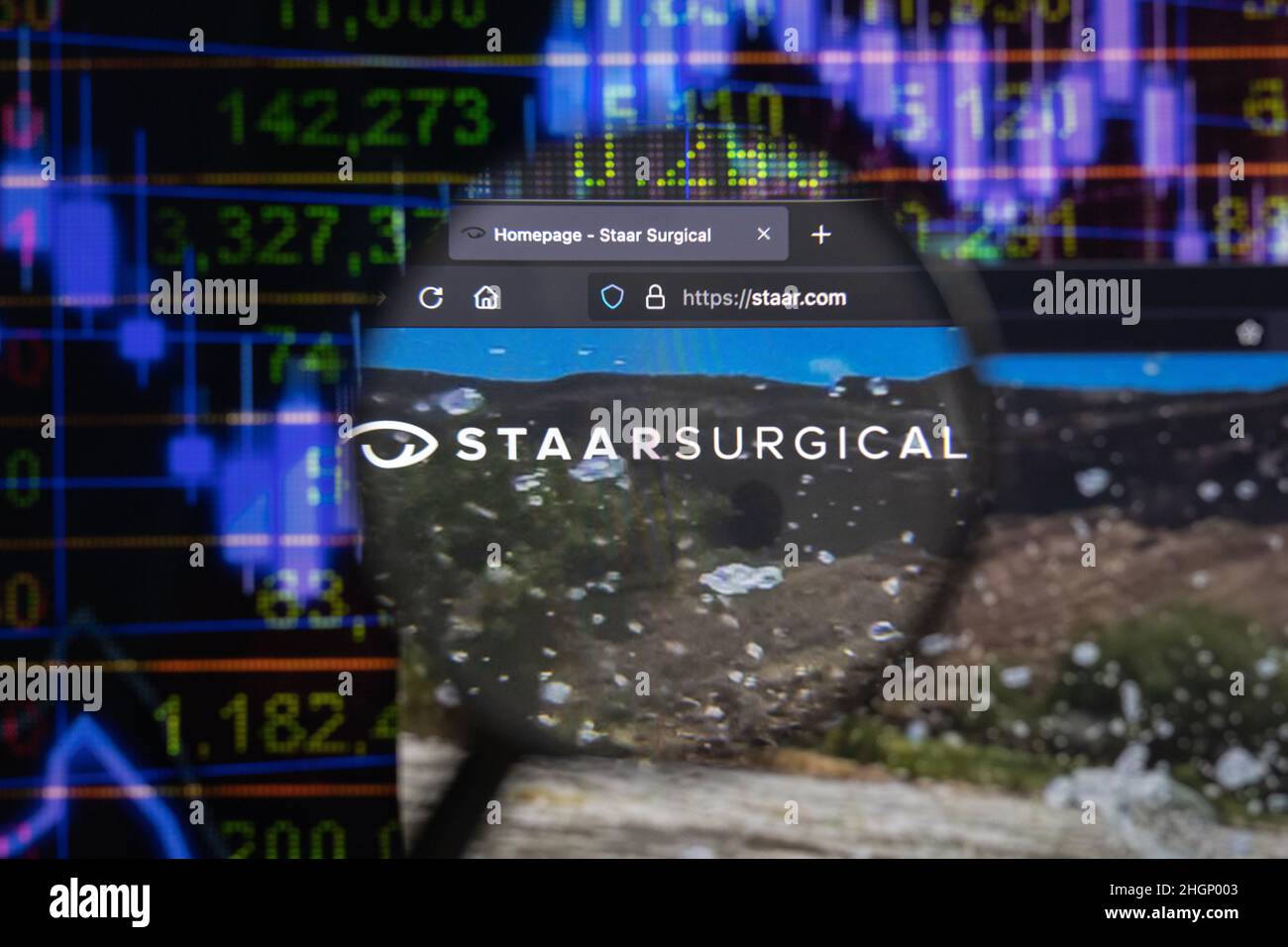 STAAR Surgical Company logo de la société sur un site Web avec des développements flous du marché boursier en arrière-plan, vu sur un écran d'ordinateur Banque D'Images