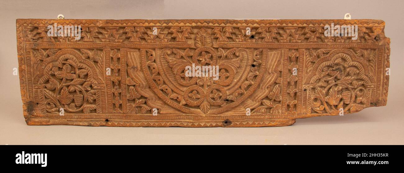 Panneau en bois sculpté 8th–9th siècle la vigne défile sous les arches de chaque côté de ce panneau sont des éléments caractéristiques de la sculpture en bois d'Umayyad et s'inspirent des traditions locales.Les ailes stylisées au centre du panneau dérivent de l'art sasanien c'est l'abstraction accrue évidente dans les deux éléments qui identifie cette pièce comme Umayyad.Panneau en bois sculpté.8th–9th siècle.Bois; sculpté.Trouvé l'Irak, Takrit.Bois Banque D'Images