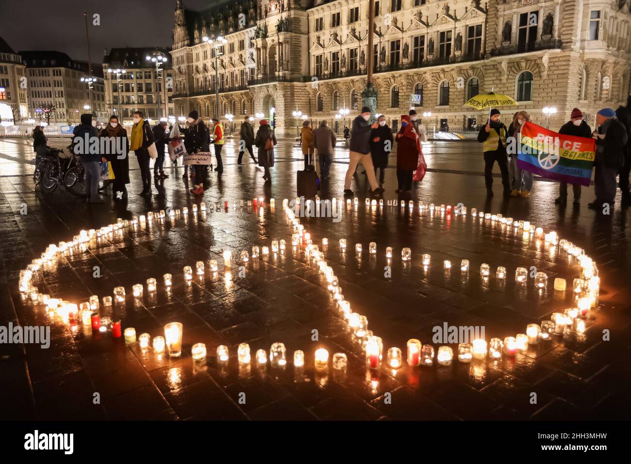 22 janvier 2022, Hambourg: Les membres de l'organisation de paix ICAN (campagne internationale pour l'abolition des armes nucléaires) manifestent par une action légère à l'occasion du premier anniversaire de l'entrée en vigueur du Traité sur l'interdiction des armes nucléaires.Un signe de paix sera formé de bougies sur l'hôtel de ville de Hambourg.Grâce à cette action nationale, le CIAN appuie la demande de l'Allemagne d'adhérer au Traité sur l'interdiction des armes nucléaires et de retirer ainsi les armes nucléaires de l'Allemagne.Photo: Bodo Marks/dpa Banque D'Images