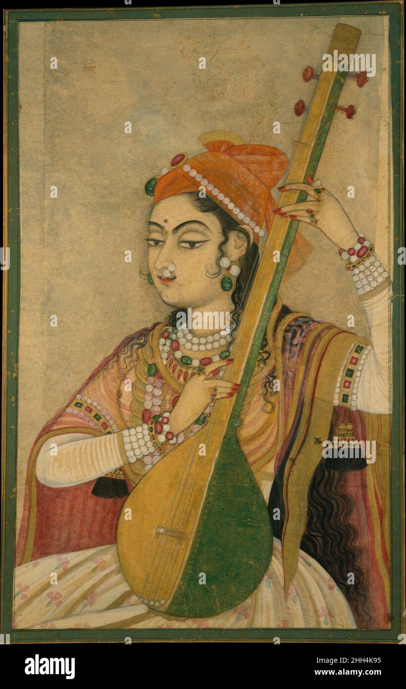 Une dame jouant le Tanpura ca.1735 Inde (Rajasthan, Kishangarh) en tant que nayika (héroïne archétypale), cette figure personnifie l'idéal de la beauté féminine tel que conceptualisé dans la poésie dévotionnelle indienne de l'époque.Elle strum un tanpura et porte des bijoux élaborés et des textiles fins, la plaçant clairement comme membre de la cour.En même temps, il y a l'allusion qu'elle est Radha, la consort divine de Krishna, qui était importante pour ces patrons de Kishangarh.Une Dame jouant le Tanpura 38038 Banque D'Images