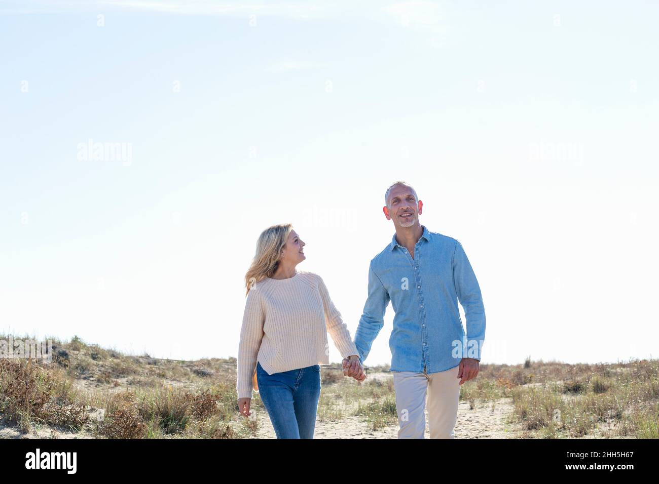 Couple marchant ensemble dans les dunes Banque D'Images Couple marchant ensemble dans les dunes Banque D'Images