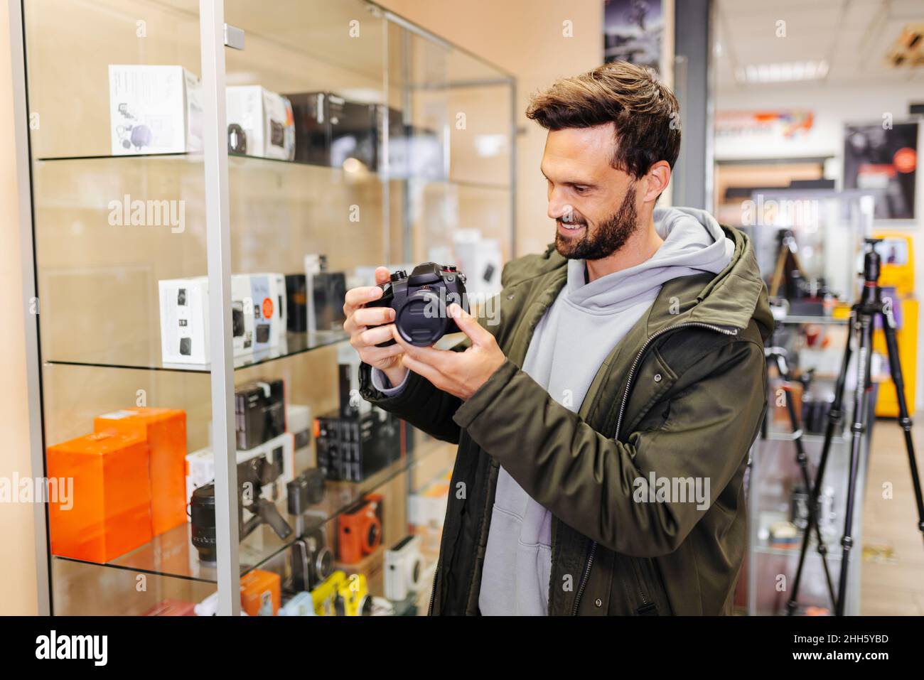 Client souriant regardant un appareil photo dans un magasin Banque D'Images