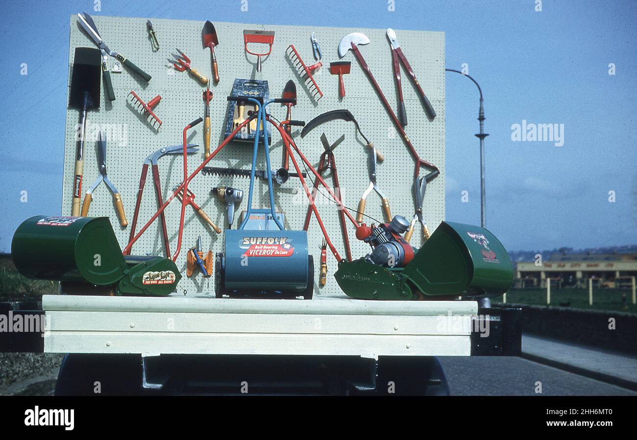 1959, historique, un défilé flottant présentant une gamme d'outils de jardin et plusieurs tondeuses à gazon de l'époque, y compris le Suffolk Viceroy tondeuse à essence, Londonderry, Irlande du Nord, Royaume-Uni. Banque D'Images