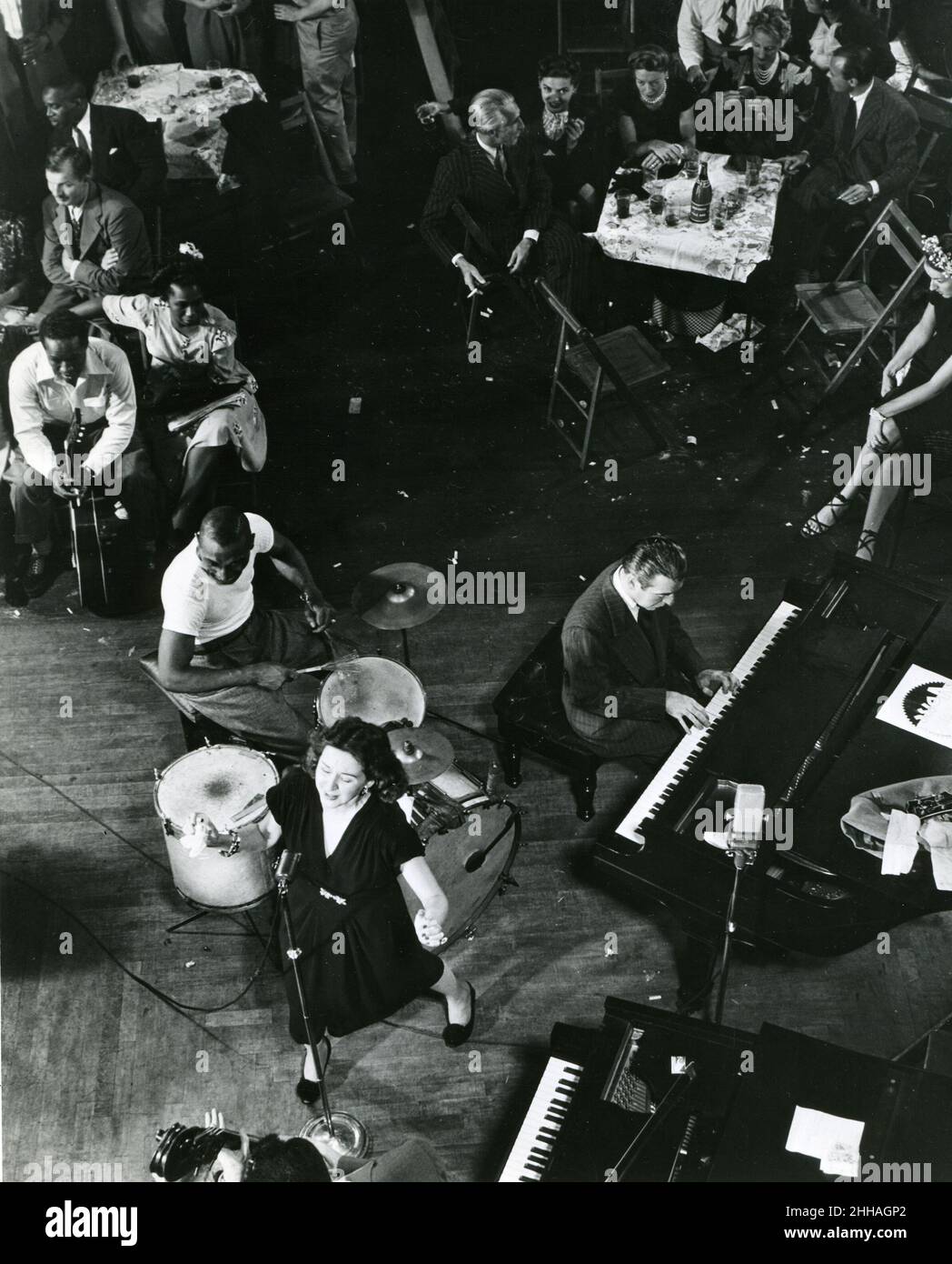 New York, vers 1945 - Lee Wiley chante « Sugar », un standard de jazz qu'elle a enregistré pour le label Commodore au centre-ville de Cafe Society.Jess Stacy, son mari est sur le piano, 'Cozy' Cole est sur la batterie et Sid Weiss sur la basse. Banque D'Images