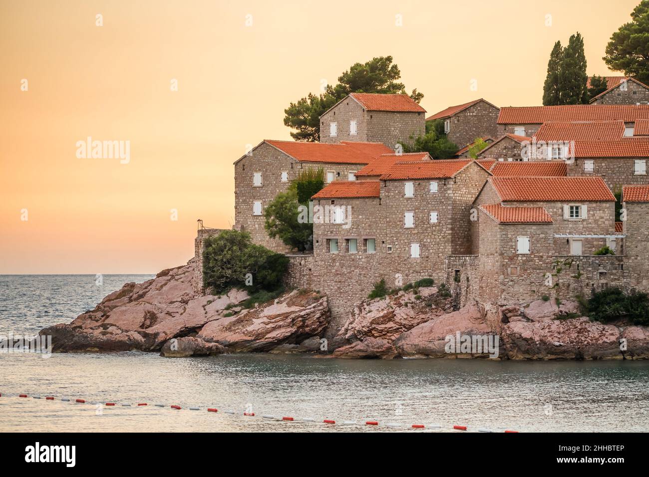 Les bâtiments historiques de l'île Sveti Stefan se rapprochent à l'aube au Monténégro Banque D'Images