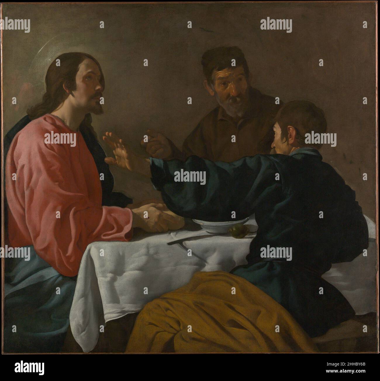 La Cène à Emmaus 1622–23 Velázquez (Diego Rodríguez de Silva y Velázquez) Espagnol ce tableau illustre le moment qui suit la Résurrection où Jésus est reconnu par deux disciples comme « il a pris du pain, béni et l'a brisé, et l'a remis à eux ».Le sujet a donné à Velázquez l'occasion d'explorer les contrastes dans les réactions par le geste, l'expression, et l'utilisation de l'éclairage dramatique.Il l'a peut-être peint à Séville, où il s'est entraîné pour la première fois, ou à Madrid, où il a déménagé en 1623.Velázquez s'inspire peut-être de l'œuvre du Caravaggio, qu'il aurait connue à travers des copies.Le dîner chez EM Banque D'Images