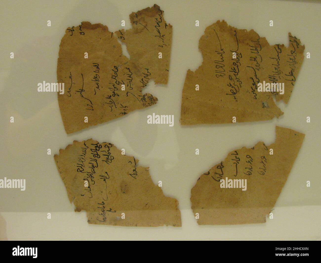 Doublure d'une casquette 12th–13th siècle ces fragments de papier arrivent au Musée comme doublure intérieure d'une casquette en soie (46.156.11a).Les lignes pliées très évidentes sont très probablement liées à cette utilisation.Alors que le textile de la casquette est attribué à Seljuq Iran, le style des inscriptions sur ces fragments de papier est semblable à Ayyubid, Fatimide tardif ou Mamluk précoce cursive scripts.Doublure d'un bouchon 450729 Banque D'Images