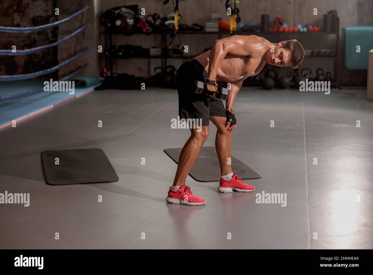 Jeune homme faisant de l'exercice de bras de sport dans la salle de gym Banque D'Images