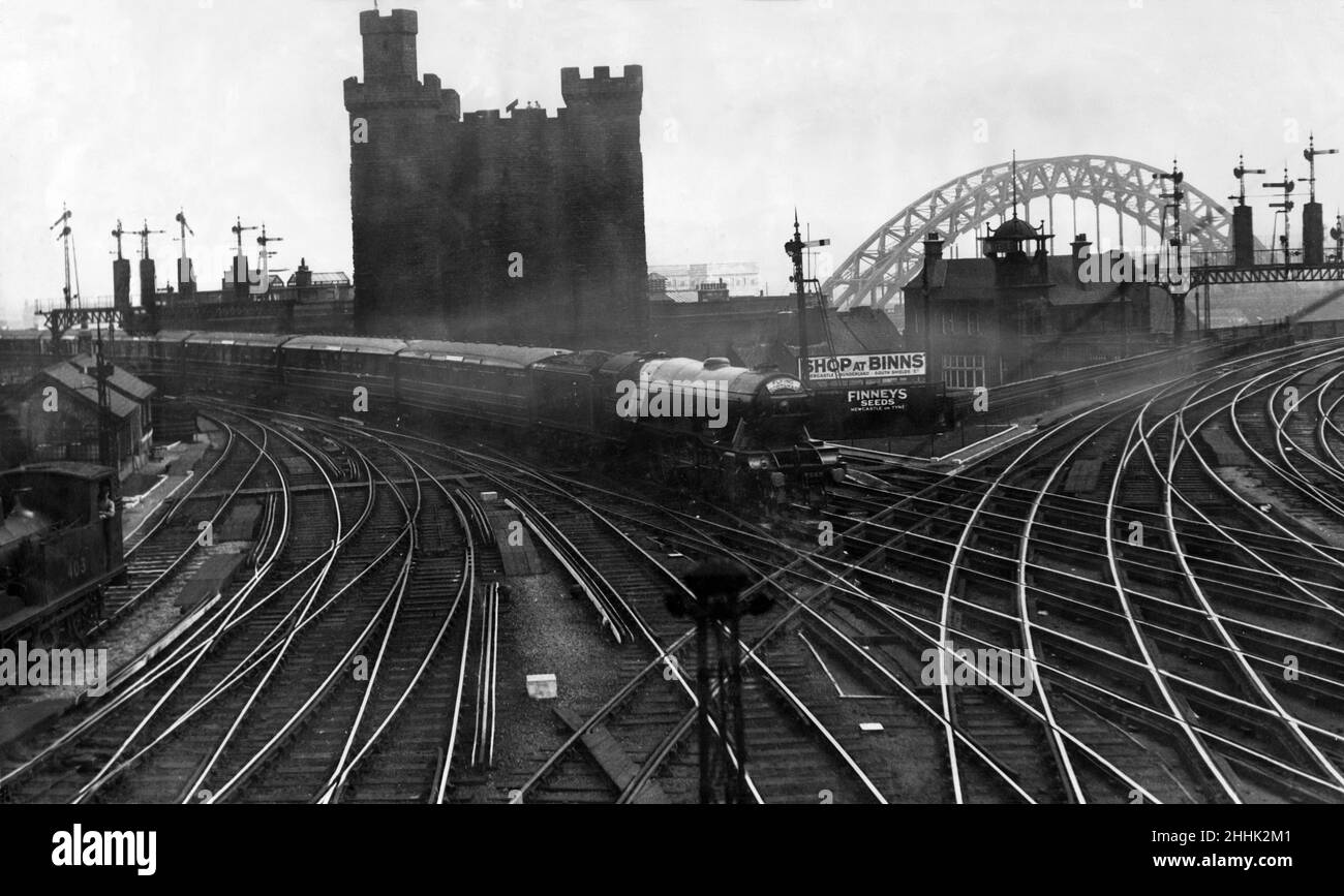 Avec un fond ancien et moderne - The Flying Scotsman express approchant la gare de Newcastle sur sa course sans escale d'Édimbourg à Londres.L'ancien château et le nouveau pont Tyne sont visibles en arrière-plan.Le célèbre chemin de fer de la gare centrale de Newcastle avant la nationalisation.11th août 1932. Banque D'Images